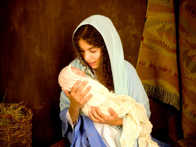 Image of Mary lifting baby Jesus high in the air